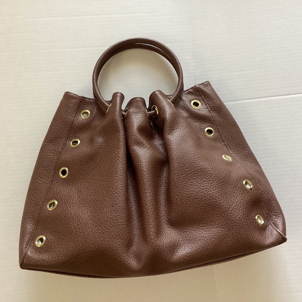 Details Brown Leather Handbag.  In Good condition with one scratch. See photo
